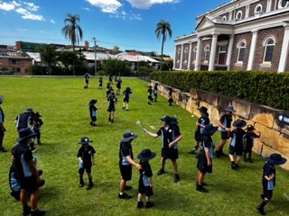 A birds eye view of children on a grassy field. 