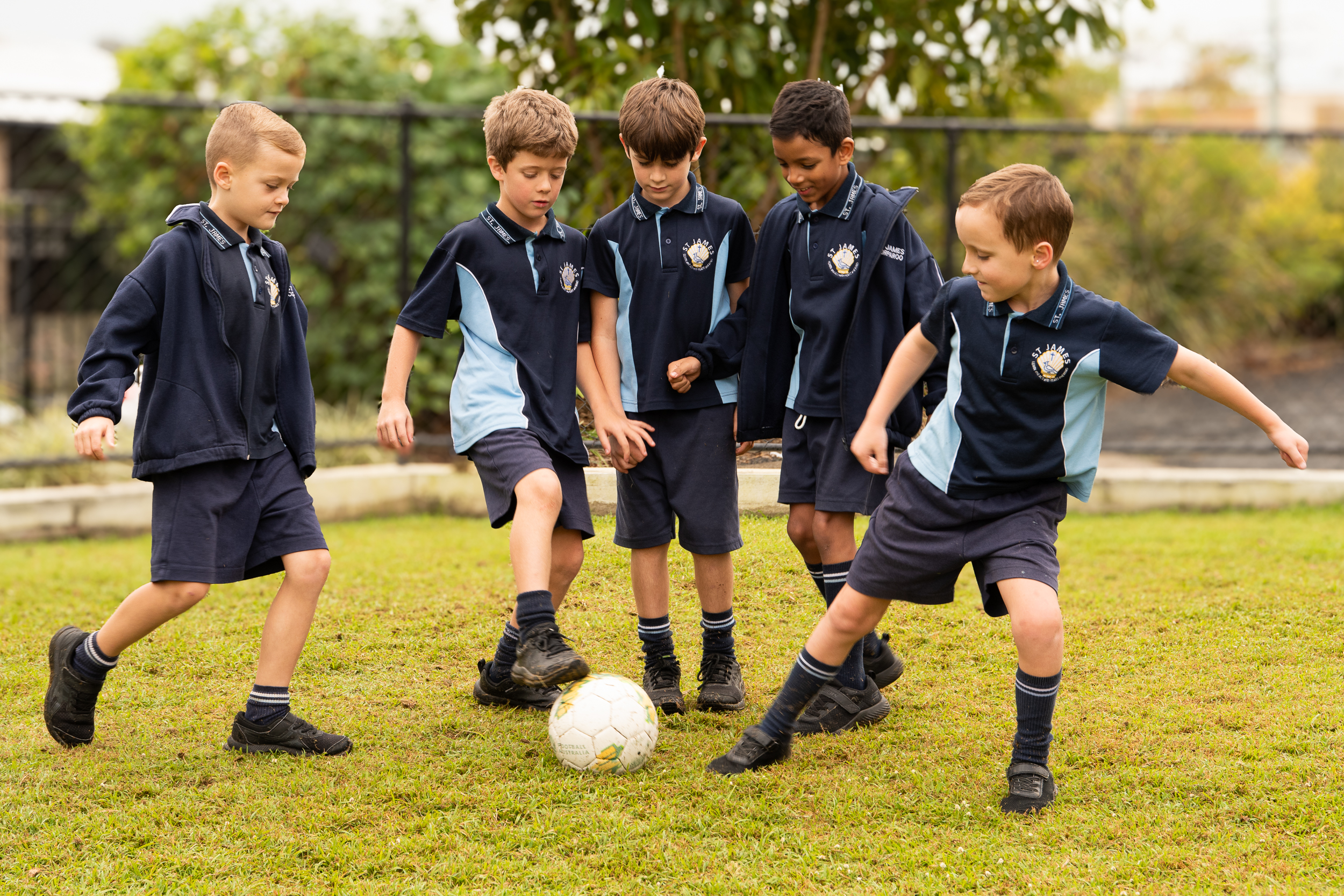 Students in a field playing soccer.